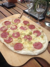 Flat bread with salami, green grapes and cheese in Germany